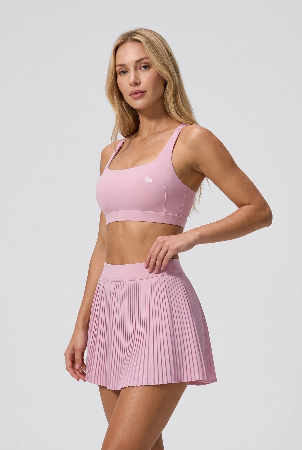 CORA bra top & pleated skirt set in Cream pink – women's padel set by Six'o – studio photo