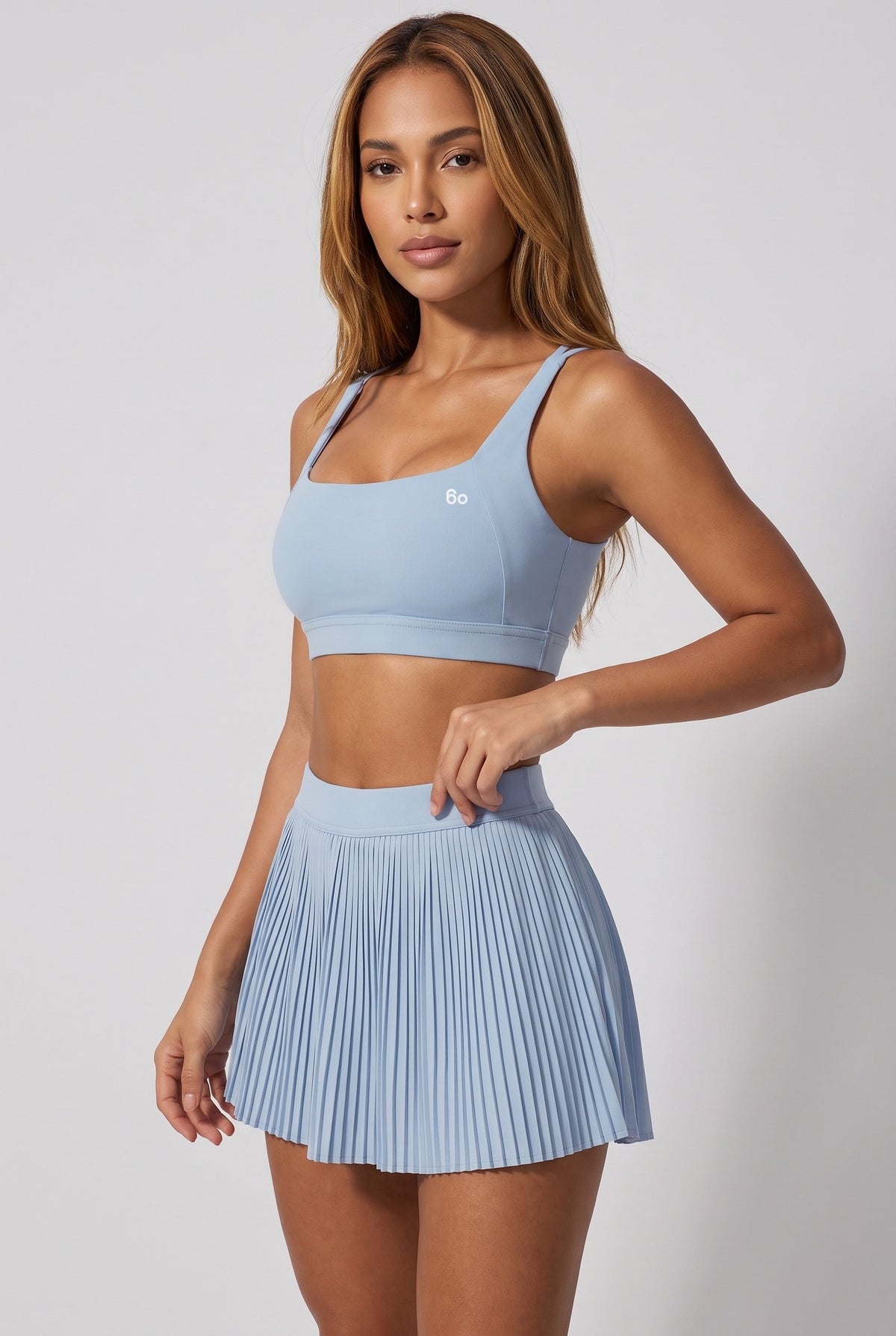 CORA bra top & pleated skirt set in Ice blue – women's padel set by Six'o – studio photo