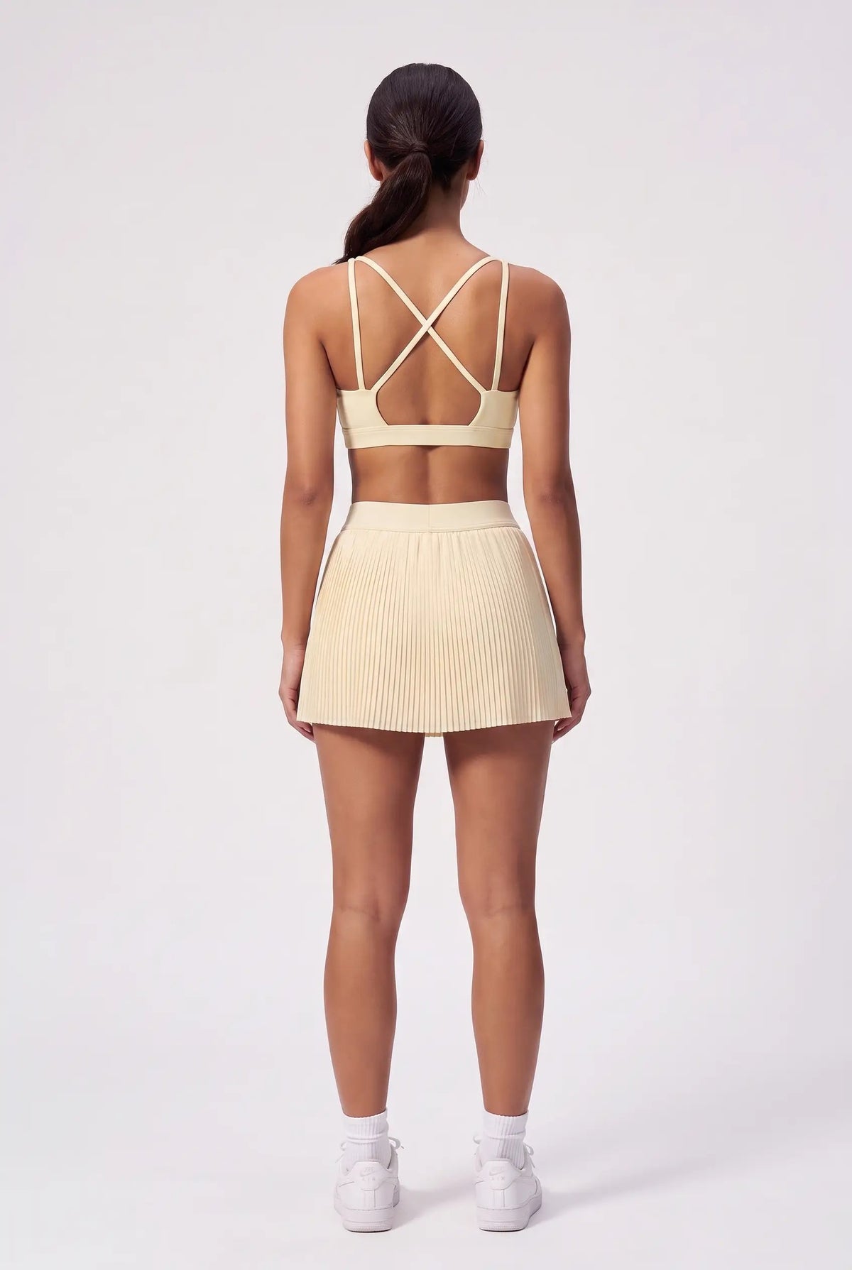 CORA bra top & pleated skirt set in Light Yellow – women's padel set by Six'o – back view