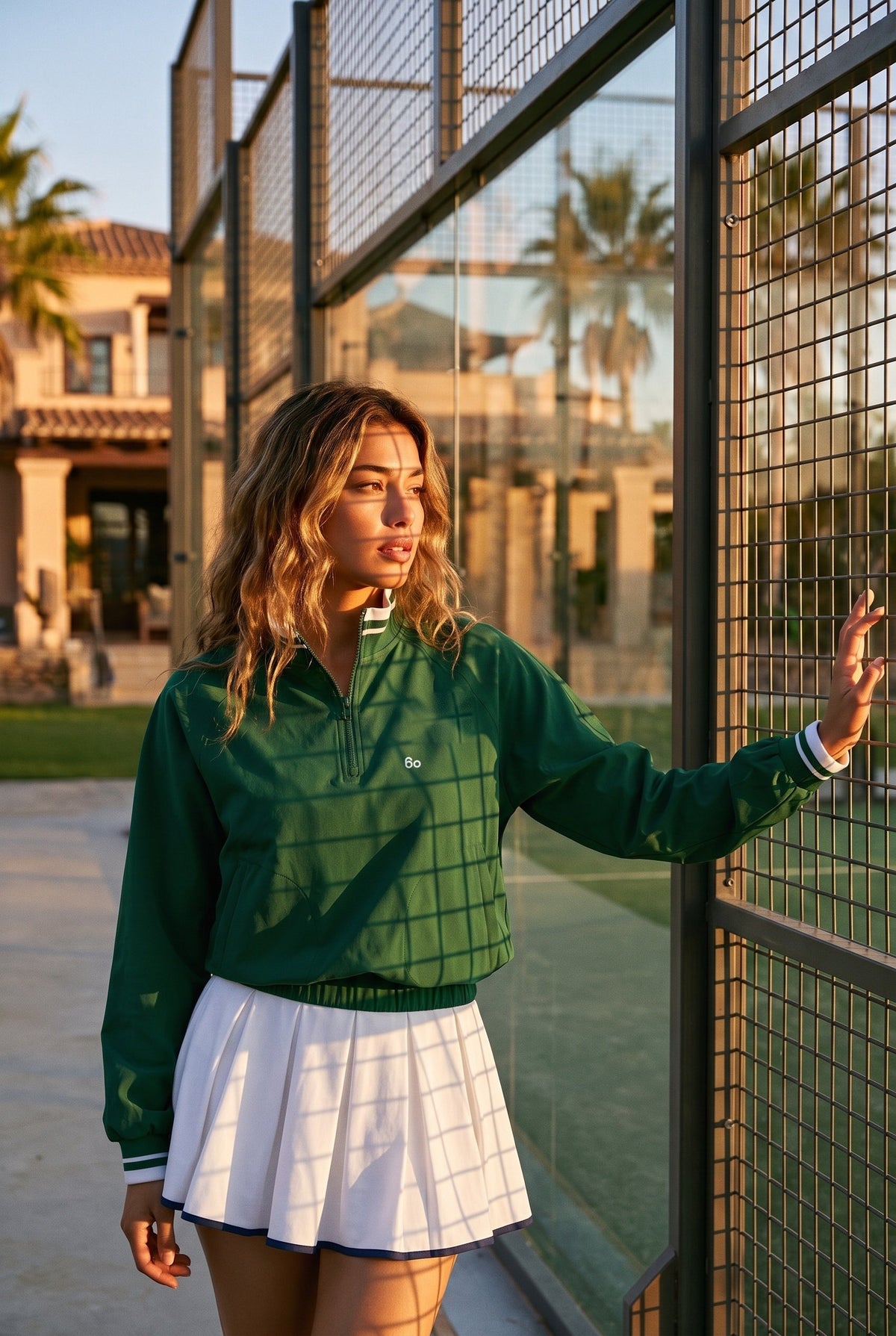 GRACE zip sweater & skirt set in Green sweater white skirt – women's padel set by Six'o – lifestyle photo at the padel club