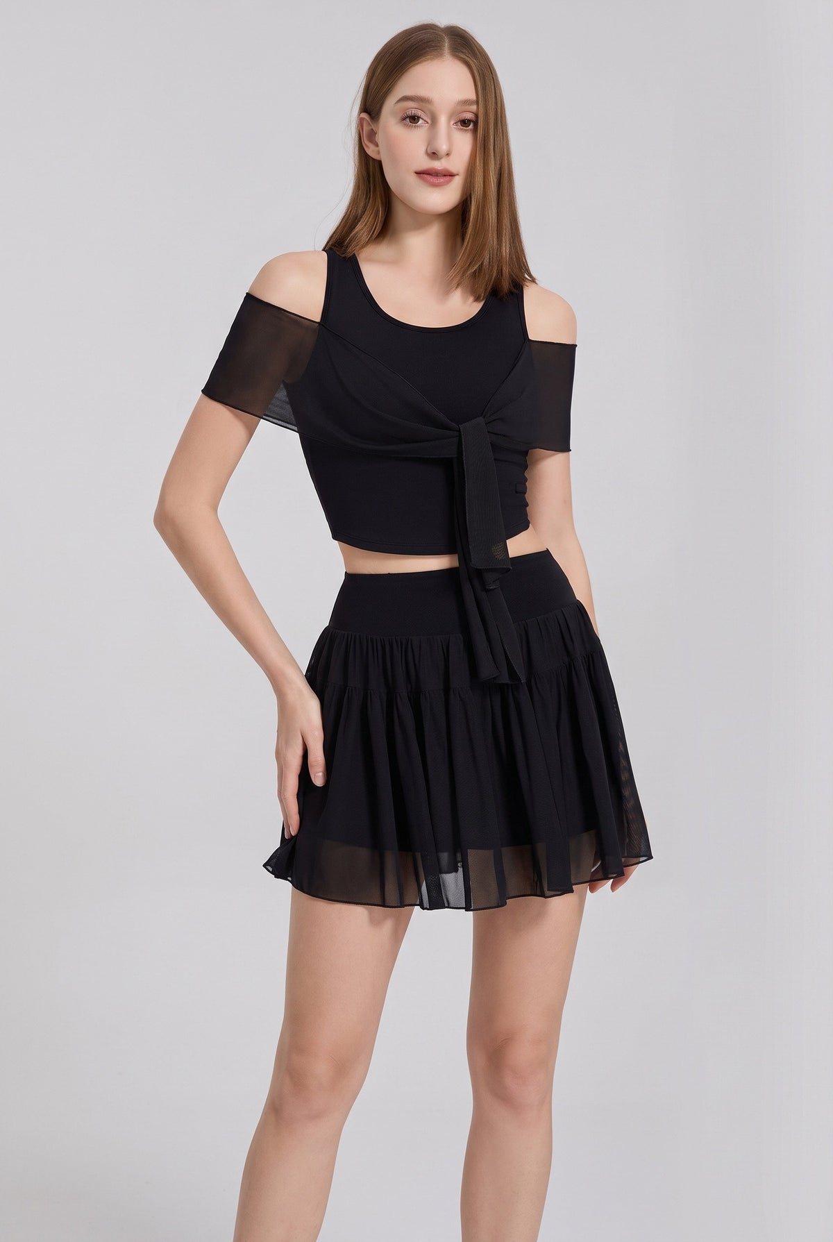 LILA cold-shoulder top & tiered skirt set in Black – women's padel set by Six'o – studio photo