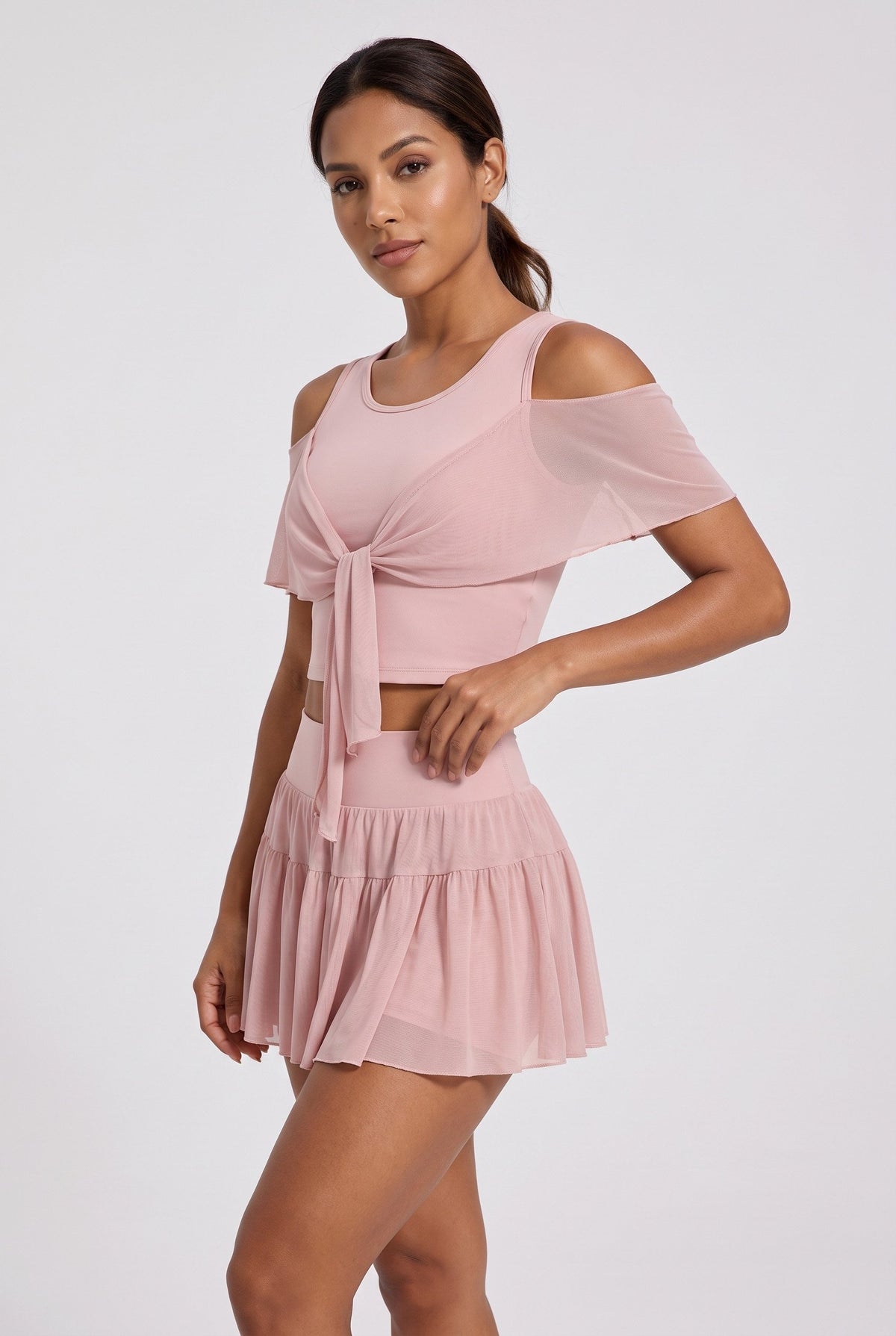 LILA cold-shoulder top & tiered skirt set in Primrose pink – women's padel set by Six'o – studio photo