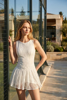 ALICE lace padel dress in White – women's padel dress by Six'o – lifestyle photo at the padel club