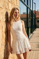ALICE lace padel dress in White – women's padel dress by Six'o – lifestyle photo at the padel club