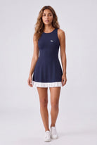AMBER cross-back padel dress in Navy – women's padel dress by Six'o – full-length studio photo