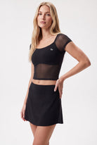 AVA mesh sleeve top & skort set in Black – women's padel set by Six'o – studio photo