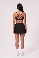 CORA bra top & pleated skirt set in Black – women's padel set by Six'o – back view