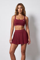 CORA bra top & pleated skirt set in Cherry red – women's padel set by Six'o – front view