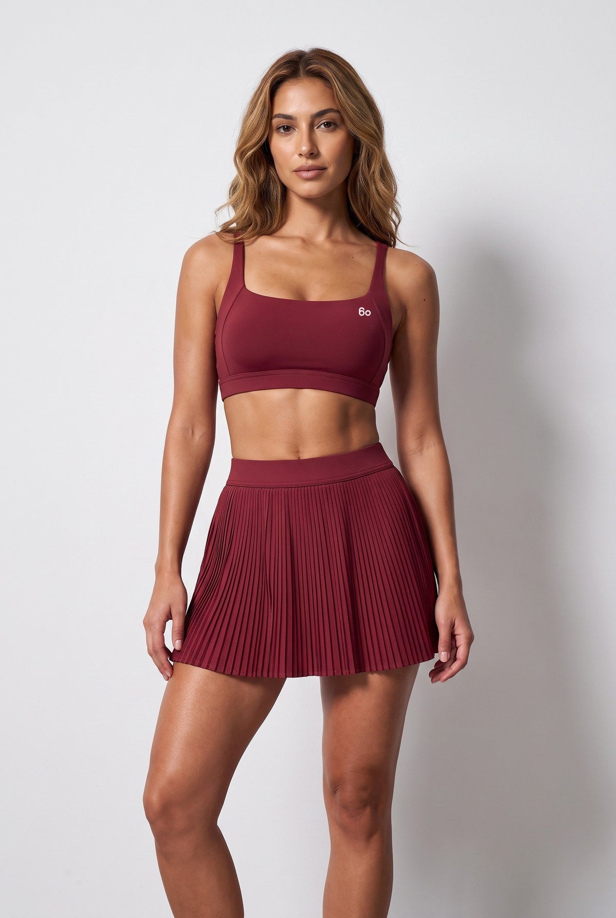 CORA bra top & pleated skirt set in Cherry red – women's padel set by Six'o – front view