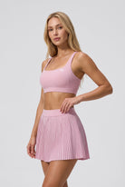 CORA bra top & pleated skirt set in Cream pink – women's padel set by Six'o – studio photo