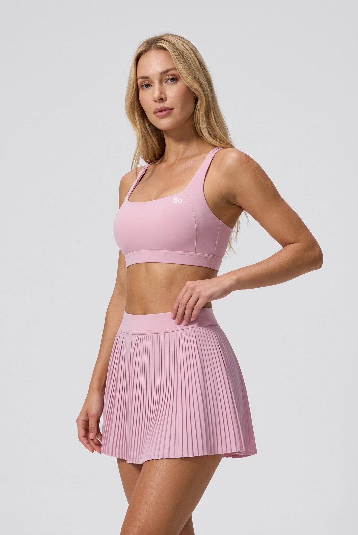 CORA bra top & pleated skirt set in Cream pink – women's padel set by Six'o – studio photo