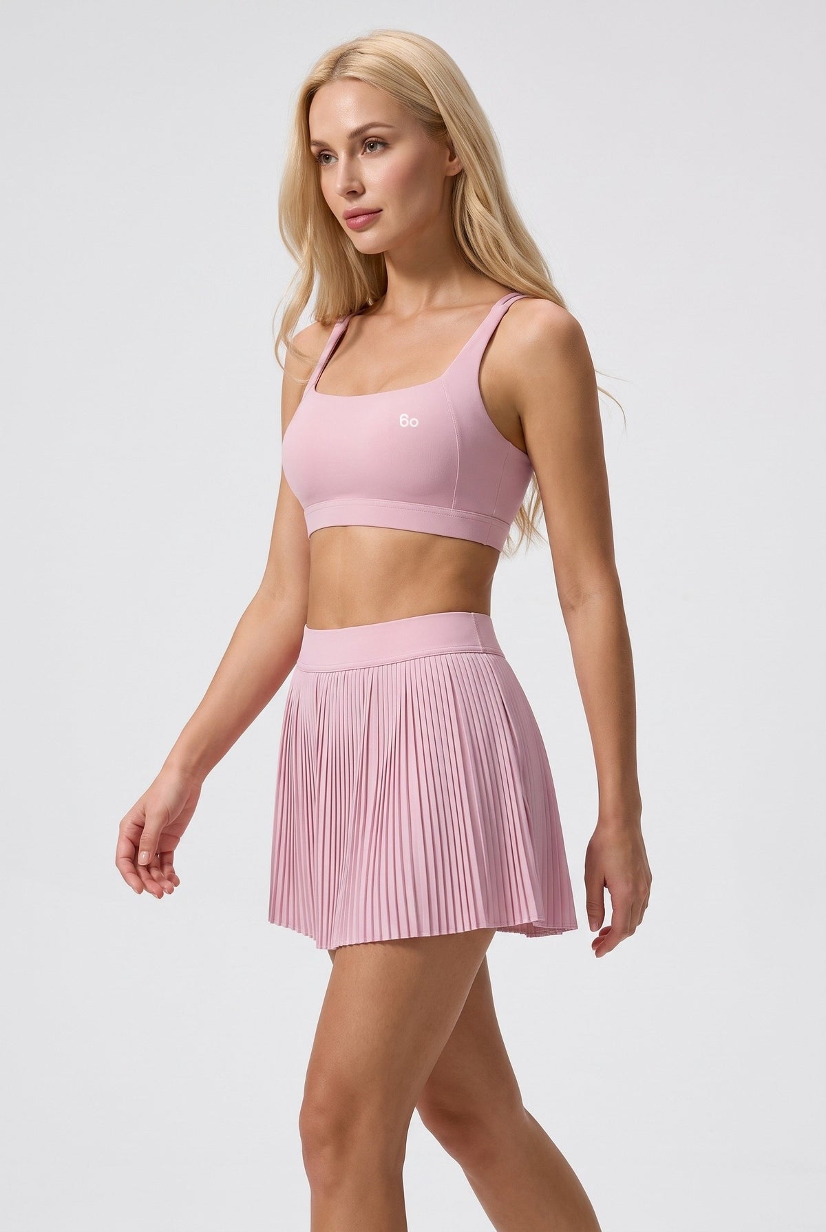 CORA bra top & pleated skirt set in Cream pink – women's padel set by Six'o – full-length studio photo