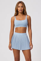 CORA bra top & pleated skirt set in Ice blue – women's padel set by Six'o – front view