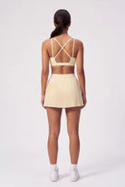 CORA bra top & pleated skirt set in Light Yellow – women's padel set by Six'o – back view