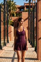 ELLA scoop neck pleated padel dress in Purple – women's padel dress by Six'o – lifestyle photo at the padel club