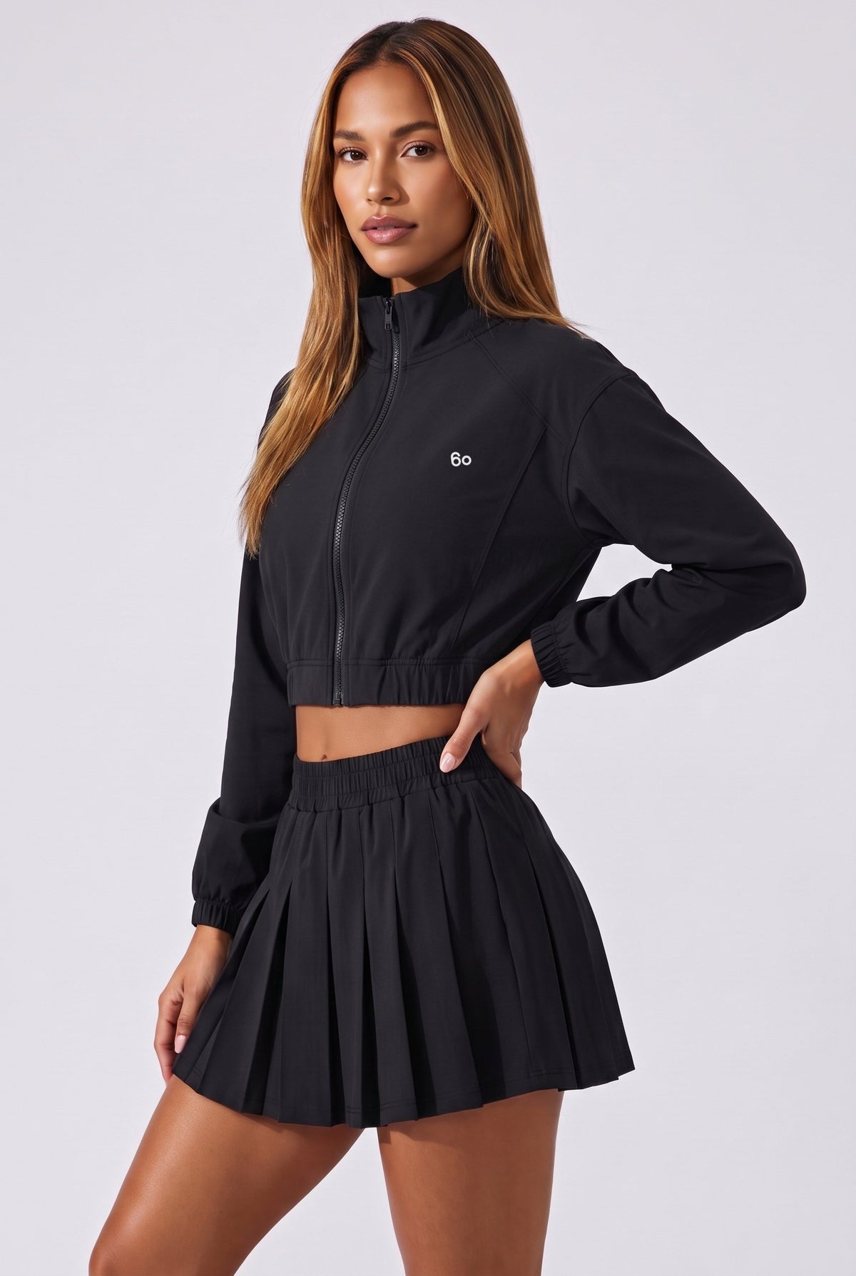 ELSA cropped jacket & pleated skirt set in Black – women's padel set by Six'o – studio photo