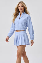 ELSA cropped jacket & pleated skirt set in Light blue – women's padel set by Six'o – full-length studio photo