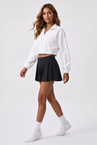 ELSA cropped jacket & pleated skirt set in White jacket black skirt – women's padel set by Six'o – full-length studio photo