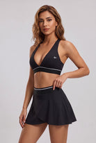 FREYA plunge bra & skirt set in Black – women's padel set by Six'o – studio photo