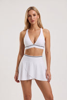 FREYA plunge bra & skirt set in White – women's padel set by Six'o – front view