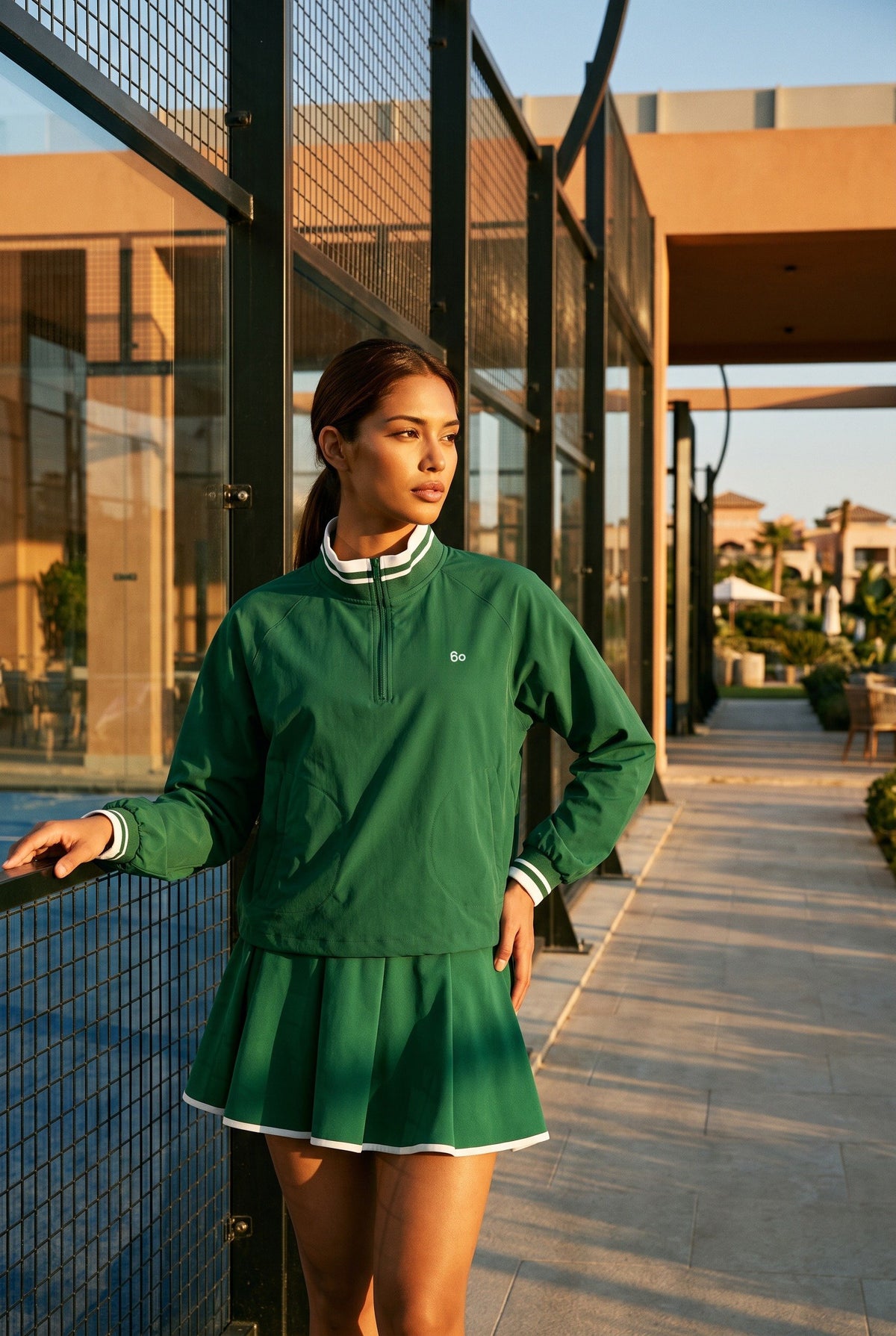 GRACE zip sweater & skirt set in Green set – women's padel set by Six'o – lifestyle photo at the padel club
