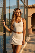 JADE cami top & skirt set in Vanilla white – women's padel set by Six'o – lifestyle photo at the padel club