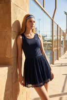 LEA square neck top & lace skirt set in Navy – women's padel set by Six'o – lifestyle photo at the padel club