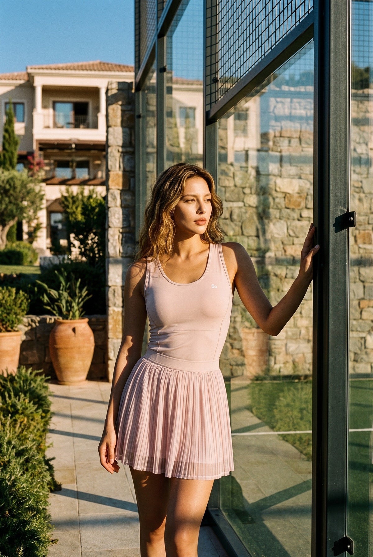 LEA square neck top & lace skirt set in Nude pink – women's padel set by Six'o – lifestyle photo at the padel club