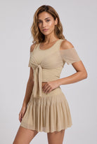 LILA cold-shoulder top & tiered skirt set in Almond yellow – women's padel set by Six'o – studio photo