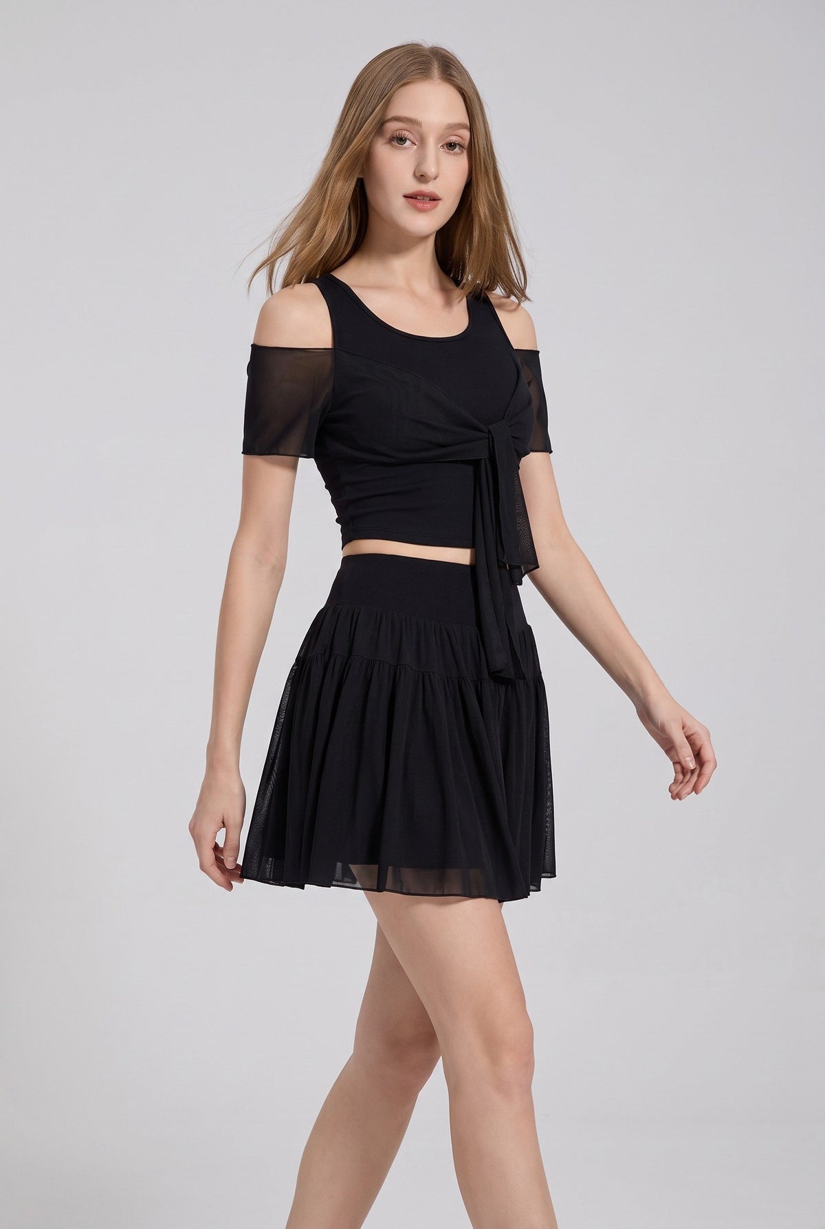 LILA cold-shoulder top & tiered skirt set in Black – women's padel set by Six'o – full-length studio photo