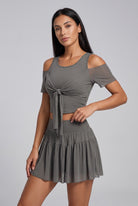 LILA cold-shoulder top & tiered skirt set in Grey – women's padel set by Six'o – studio photo