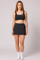 LIV bra top & wrap skirt set in Black – women's padel set by Six'o – front view