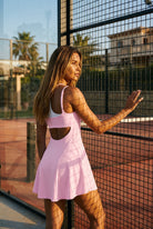LOLA racerback padel dress in Sakura pink – women's padel dress by Six'o – lifestyle photo at the padel club