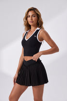LUNA v-neck top & pleated skirt set in Black – women's padel set by Six'o – studio photo