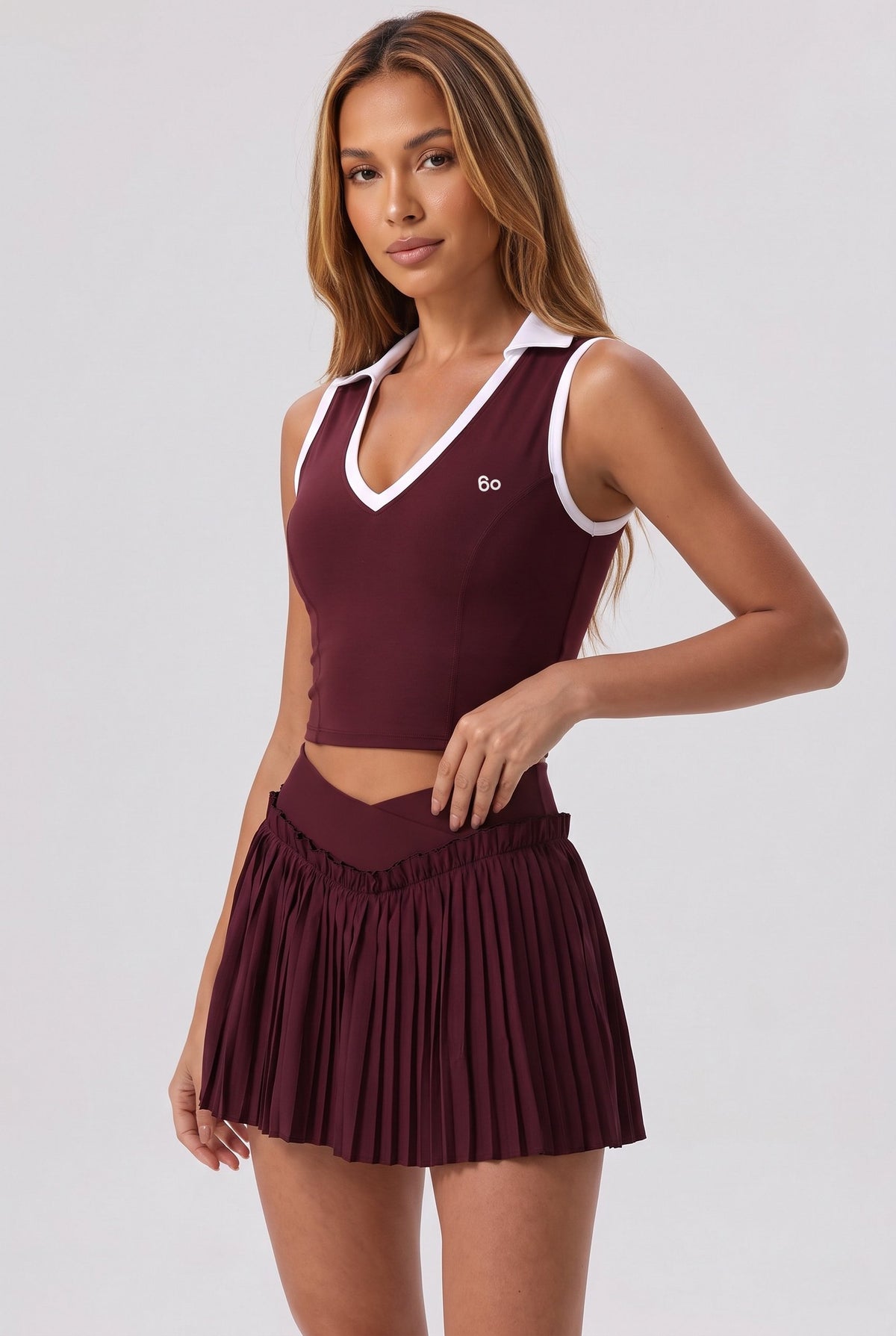 LUNA v-neck top & pleated skirt set in Burgundy – women's padel set by Six'o – studio photo
