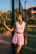 LUNA v-neck top & pleated skirt set in Pink – women's padel set by Six'o – lifestyle photo at the padel club