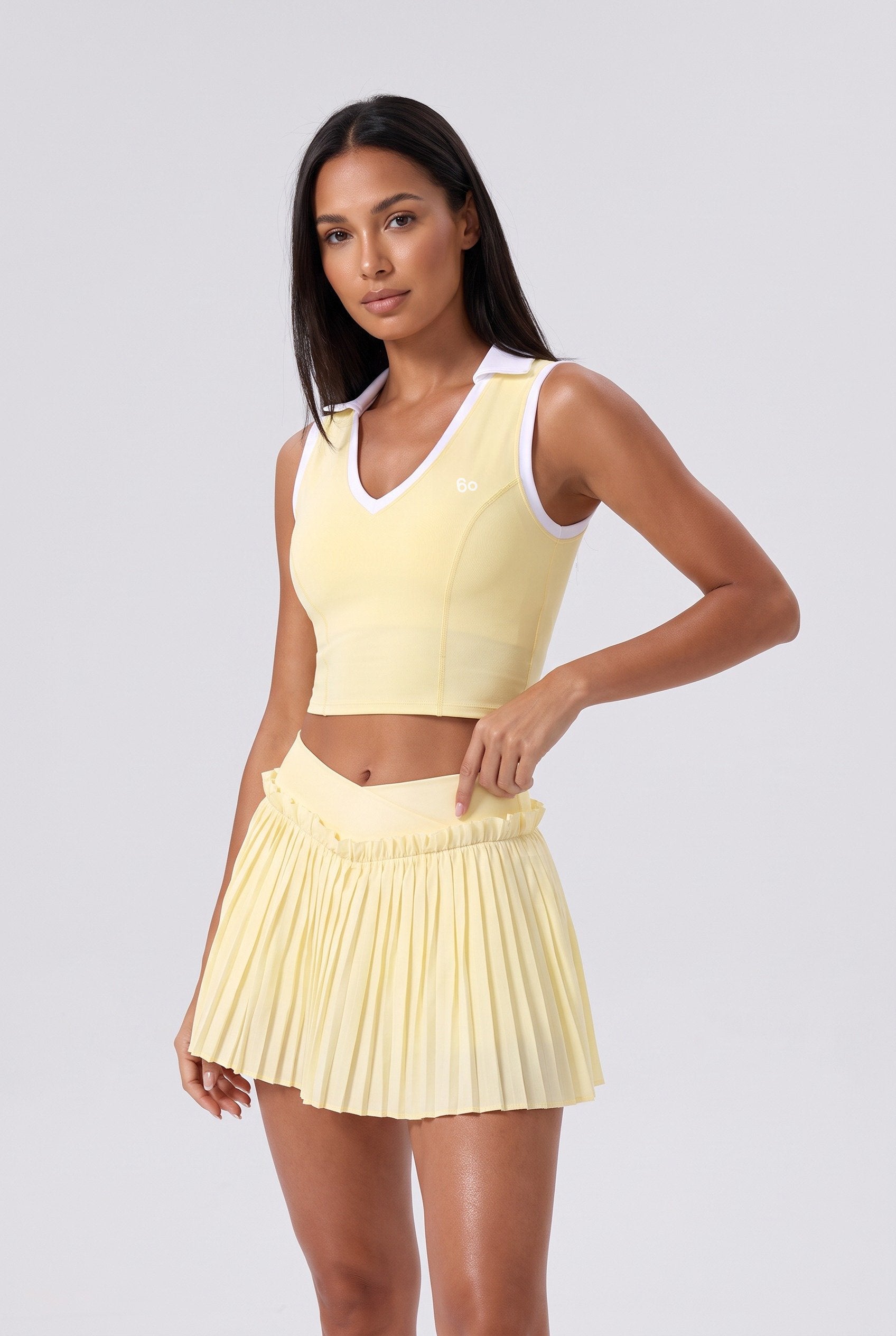 LUNA v-neck top & pleated skirt set in Yellow – women's padel set by Six'o – studio photo