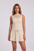 MAYA mesh tank & pleated skirt set in Milk apricot – women's padel set by Six'o – front view