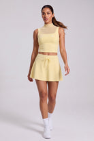MAYA mesh tank & pleated skirt set in Pear yellow – women's padel set by Six'o – full-length studio photo