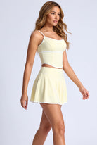 NINA cami top & flare skirt set in Pear yellow – women's padel set by Six'o – full-length studio photo
