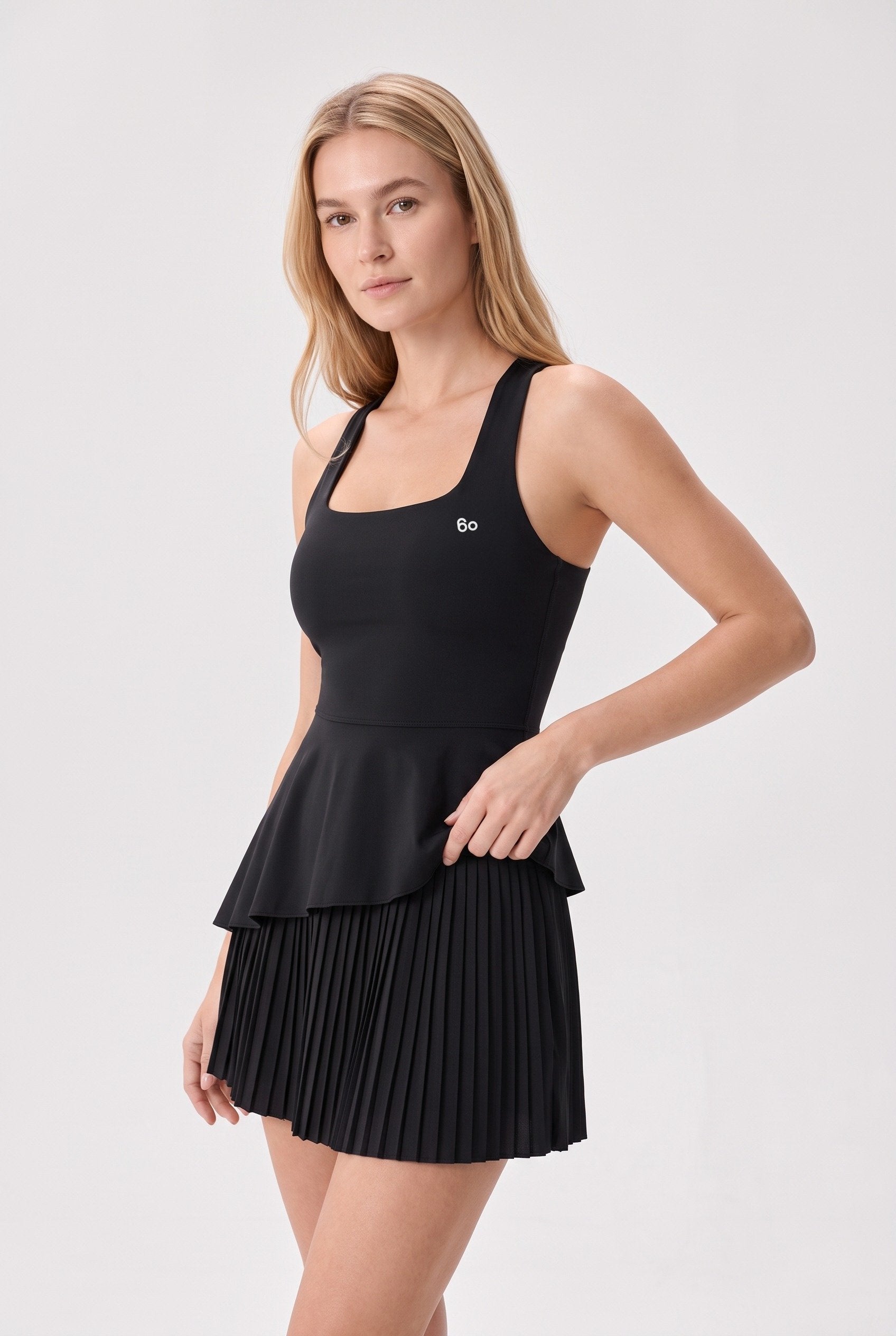 NOVA layered ruffle padel dress in Black – women's padel dress by Six'o – studio photo