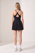 NOVA layered ruffle padel dress in Black – women's padel dress by Six'o – back view