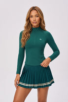 STELLA long sleeve & pleated skirt set in Dark green – women's padel set by Six'o – studio photo