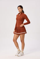 STELLA long sleeve & pleated skirt set in Rust red – women's padel set by Six'o – studio photo