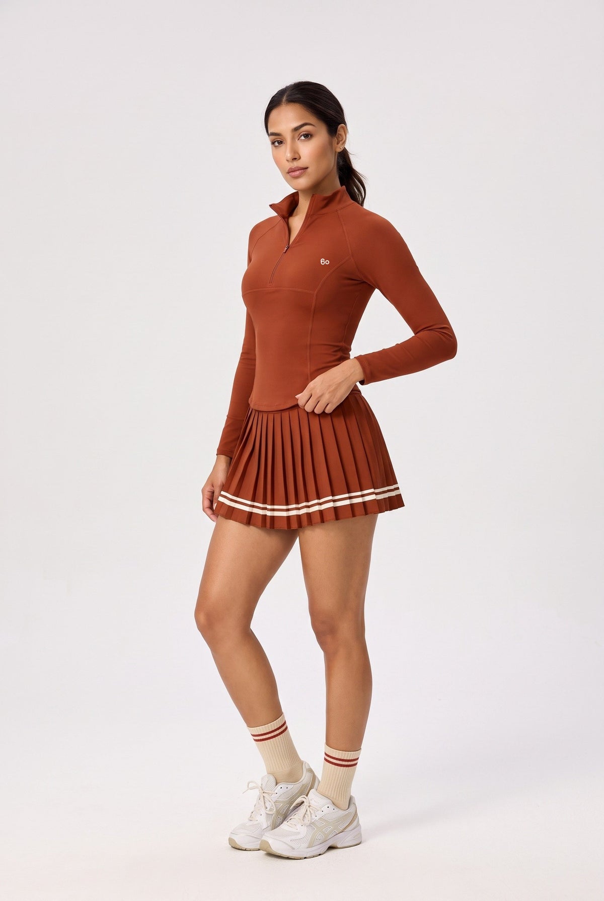 STELLA long sleeve & pleated skirt set in Rust red – women's padel set by Six'o – studio photo