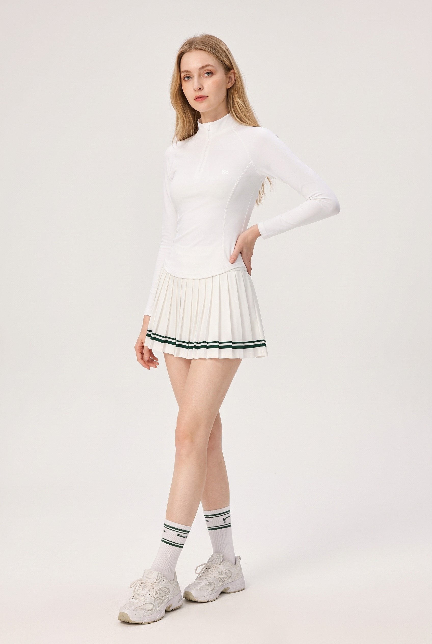 STELLA long sleeve & pleated skirt set in White – women's padel set by Six'o – studio photo
