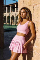 TESSA striped tank & pleated skirt set in Pink diamond – women's padel set by Six'o – lifestyle photo at the padel club